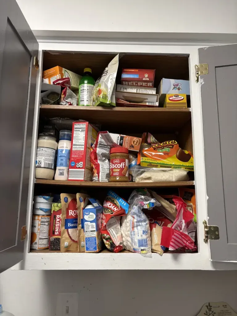 overcrowded kitchen pantry cabinet before organizing, Winchester VA