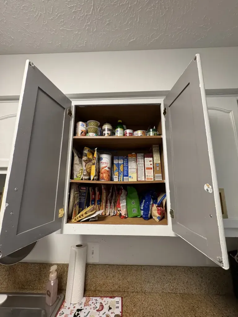 organized kitchen pantry cabinet with sorted, visible shelves after professional organizing, Winchester VA