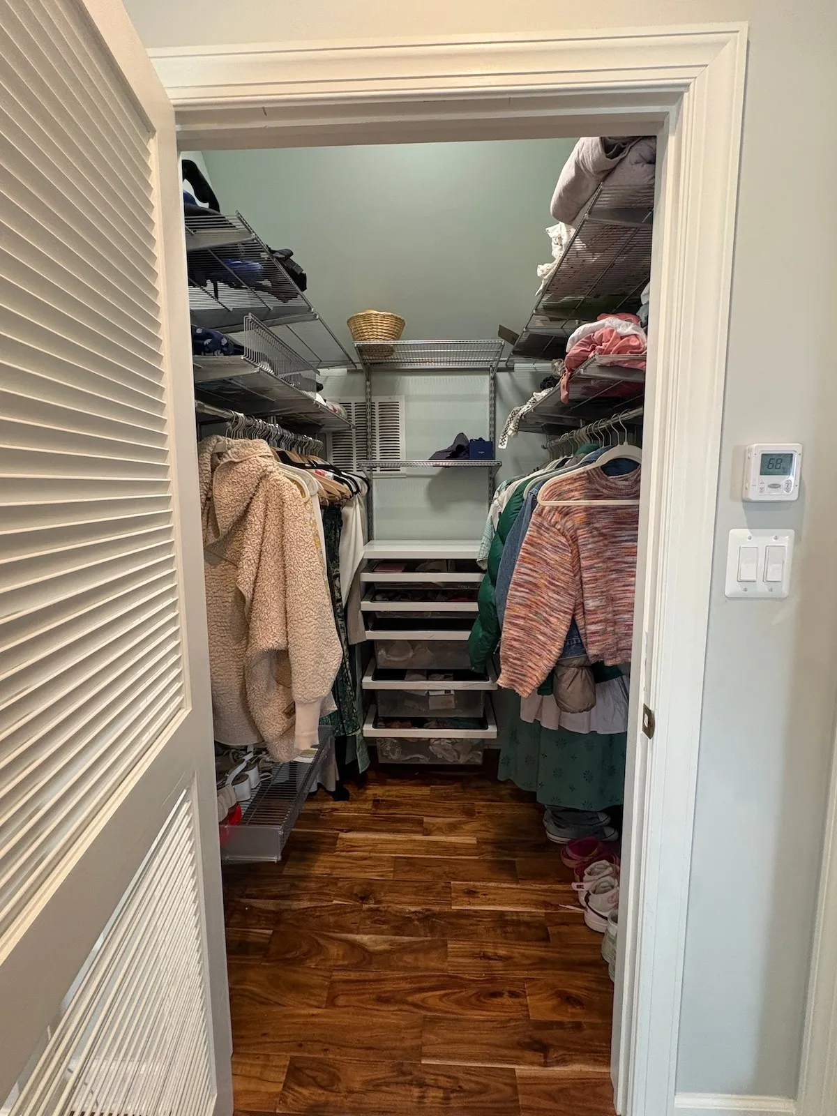 Organized walk-in closet with clear floor space after decluttering