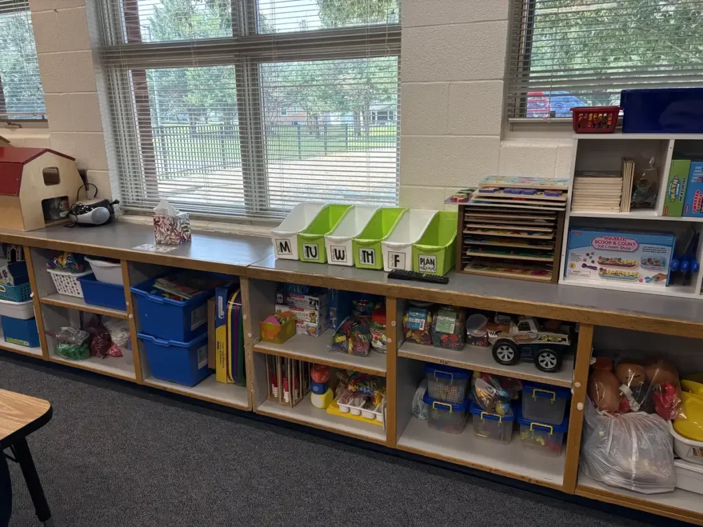 Organized preschool classroom storage with labeled daily bins and puzzle rack, Winchester VA